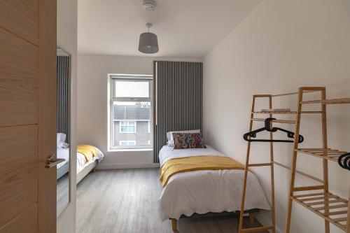 a small room with a bunk bed and a ladder at Sunbeam House 3 Morecambe in Morecambe
