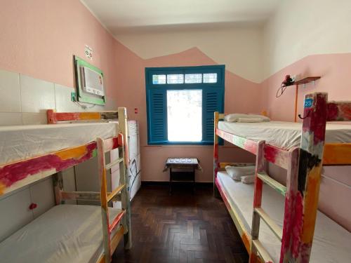 a room with three bunk beds and a window at Zili Pernambuco - Hostel Pousada in Recife