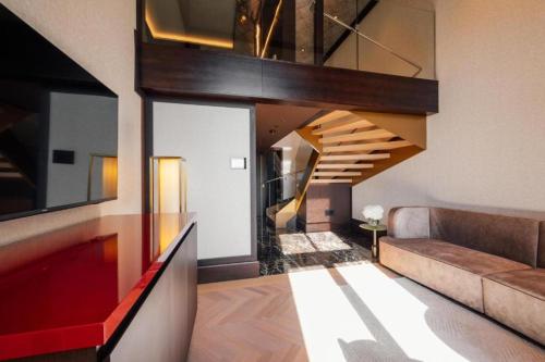 a living room with a staircase in a house at Almanac Palais Vienna in Vienna