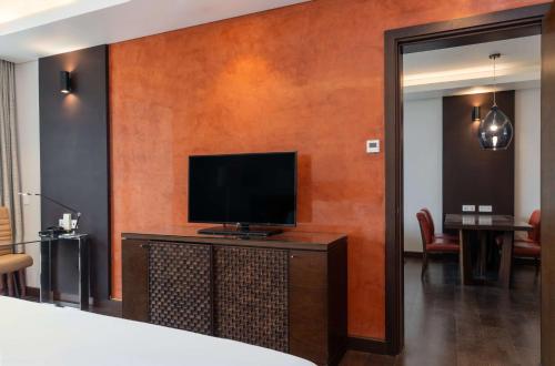 a living room with a flat screen tv on a table at Radisson Blu Hotel, Conakry in Conakry