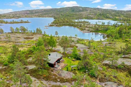 an aerial view of a house on a hill next to a lake at Traditional Cabin By Reinsvatn In Treungen in Treungen