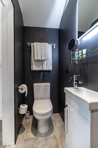 a bathroom with a white toilet and a sink at Sunbeam House 3 Morecambe in Morecambe