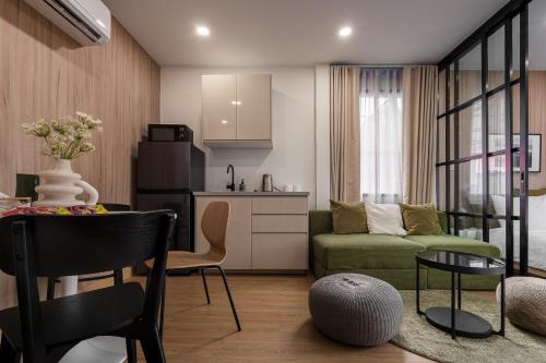 a kitchen and a living room with a couch and a table at 3 Bed 3 Bath / Luxury / 1 min walk to BTS Asok in Bangkok