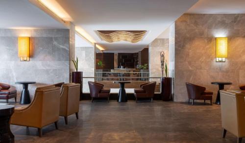 a restaurant with chairs and a table and a bar at Radisson Blu Hotel, Conakry in Conakry