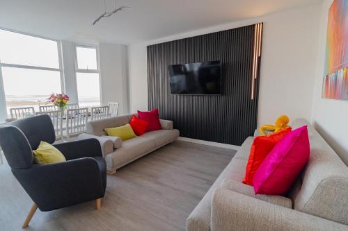 a living room with two couches and a flat screen tv at Sunbeam House 3 Morecambe in Morecambe