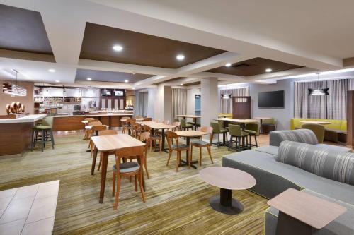 a rendering of a restaurant with tables and chairs at Courtyard by Marriott Oklahoma City Northwest in Oklahoma City