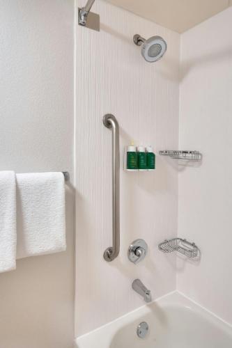a white bathroom with a shower and a sink at Courtyard by Marriott Oklahoma City Northwest in Oklahoma City