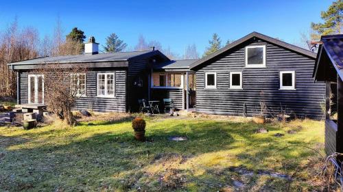 a black house in a yard with a yard at Atmosphere And Space At The Home By Vig in Vig
