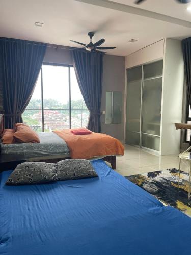 a bedroom with two beds and a ceiling fan at Urban 360 Studio Love Rara Suite Homestay in Batu Caves