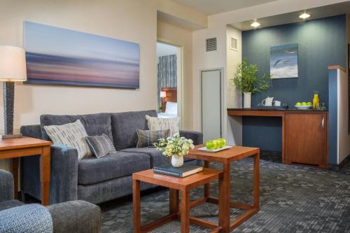 a living room with a couch and a table at Courtyard Burlington Harbor in Burlington