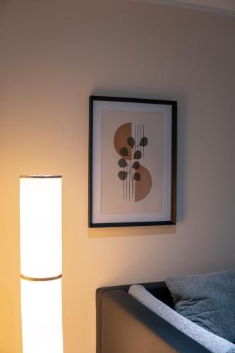 a picture hanging on a wall next to a couch at Ferienhaus Wesseling in Wesseling
