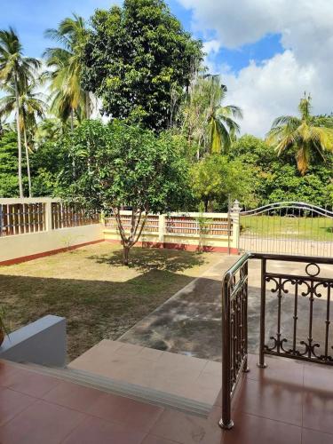 a balcony with a fence and a park at House in Lipa Noi in Ban Na We