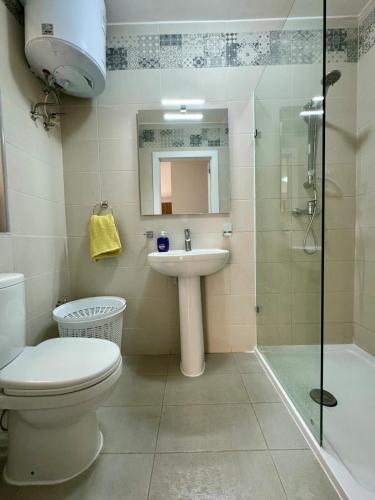 a bathroom with a toilet and a sink and a shower at MIVE-Delux Three Bedroom Apartment in Marsaskala in Marsaskala