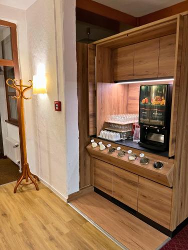 a room with a kitchen with a microwave at AMBER HOTEL Bavaria in Bad Reichenhall