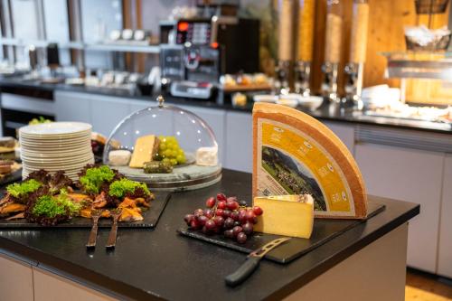 a table with food on a counter in a restaurant at MONDI Resort und Chalet Oberstaufen in Oberstaufen