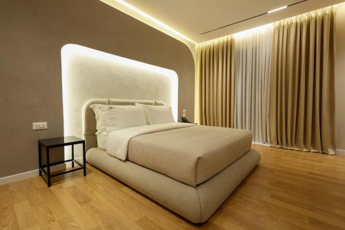 a bedroom with a bed with a large headboard at Beratinus1 in Berat