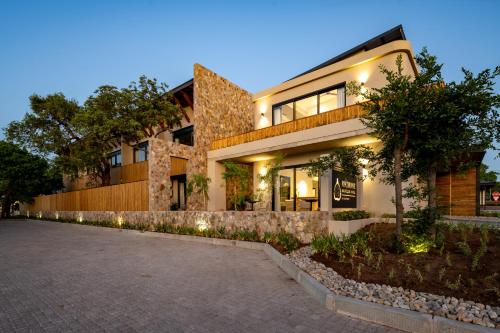 a building with lights on the side of it at Khiwane Boutique Hotel in Hoedspruit