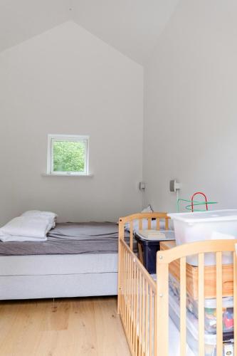 a bedroom with two bunk beds and a window at Architect-Designed Home With Outdoor Space in Hundested