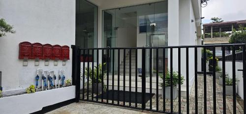 a black fence in front of a house at Rodrigo Apartments 3 in Boralesgamuwa