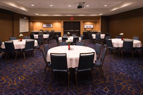 a conference room with tables and chairs with white table cloth at Courtyard by Marriott Hot Springs in Hot Springs