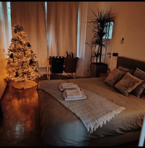 a bedroom with a christmas tree and a bed at 2Bangkok residence in Ghent