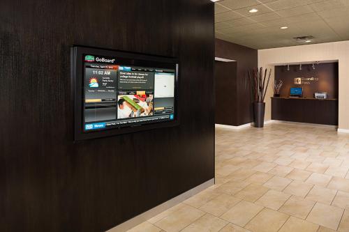 a flat screen tv on a wall in a lobby at Courtyard by Marriott Houston Medical Center/NRG Park in Houston