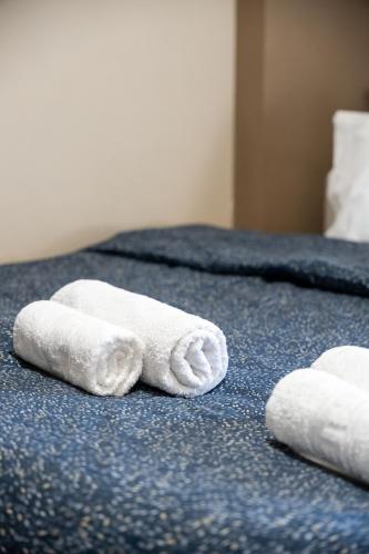 two towels are sitting on top of a bed at Indoor pool villa, near the beach, Lagonisi in Kalívia Thorikoú
