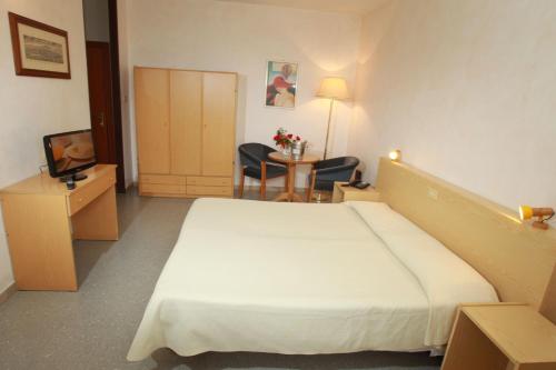 En eller flere senger på et rom på Hotel San Vitale