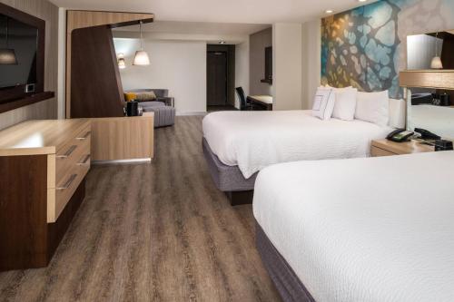 a hotel room with two beds and a television at Courtyard by Marriott Temecula Murrieta in Murrieta
