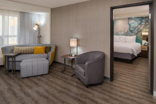 a hotel room with a bed and a chair at Courtyard by Marriott Temecula Murrieta in Murrieta