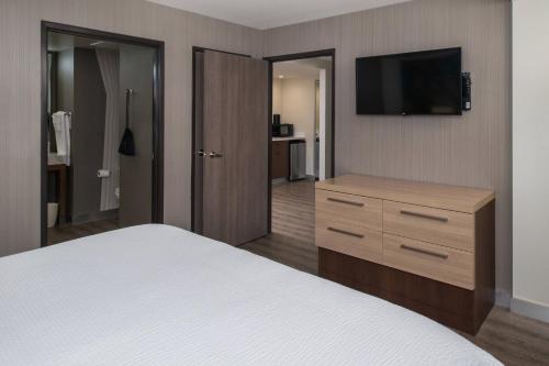 a hotel room with a bed and a flat screen tv at Courtyard by Marriott Temecula Murrieta in Murrieta