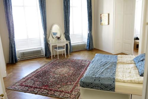 a bedroom with a bed and a mirror and a rug at aeki CITY in Vienna