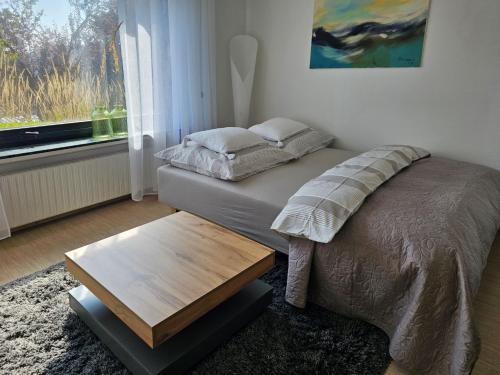 a bedroom with a bed with a table and a window at Quartier 2 in Fulda
