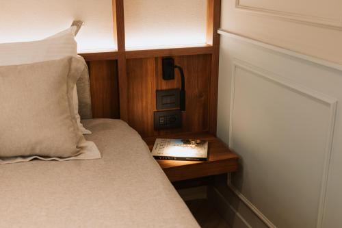 a bedroom with a bed with a book on a table at Parc Suites by Hotel Cerbul in Sinaia