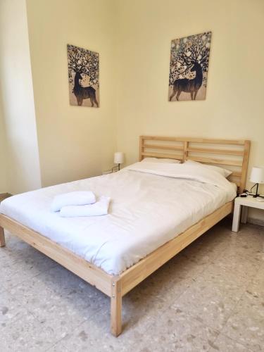 a bedroom with a bed with two towels on it at A villa in the desert in Midreshet Ben Gurion