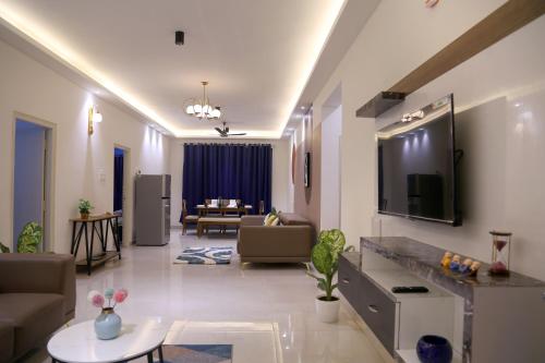 a living room with a couch and a table at Casa Nova - 3BHK - Gachhibowli in Kondapur