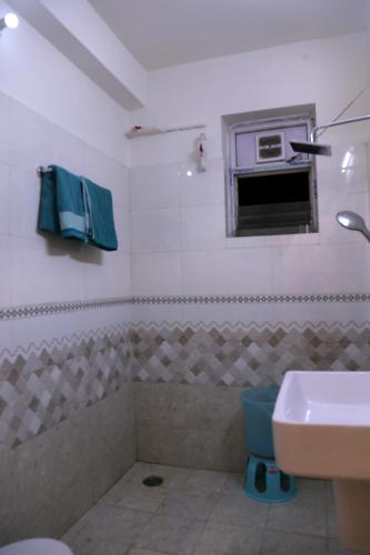 a bathroom with a sink and a microwave at Casa Nova - 3BHK - Gachhibowli in Kondapur