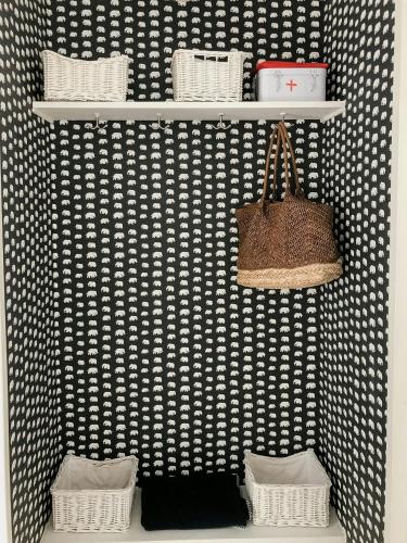 a shelf with baskets and a purse on a wall at Idyllic Holiday Home With Scenic Views On Älgö in Saltsjöbaden