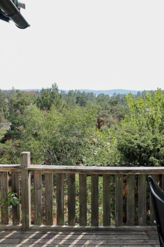a wooden deck with a view of a forest at Idyllic Holiday Home With Scenic Views On Älgö in Saltsjöbaden