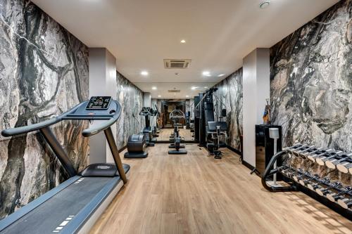 a fitness room with treadmills and treadleys at The One Alma Paris in Paris