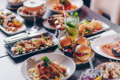 a table topped with plates of food and drinks at County Hotel & County Aparthotel Newcastle in Newcastle upon Tyne