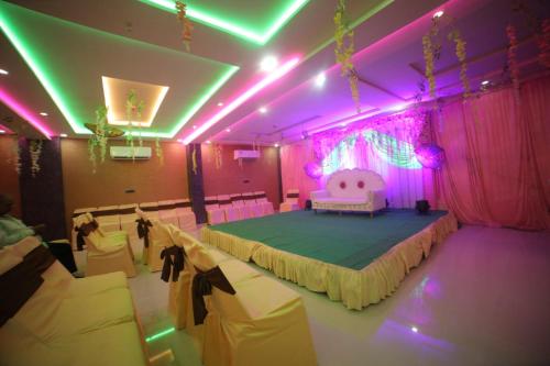 a room with a bed in a room with pink lights at Hotel Dev Vilas , Agra in Agra