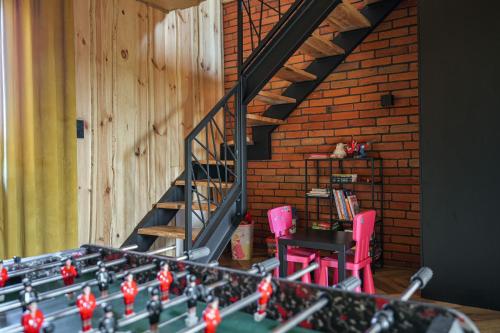 a staircase with two pink chairs and a table at Dadajowa Osada - Dadaj in Biskupiec