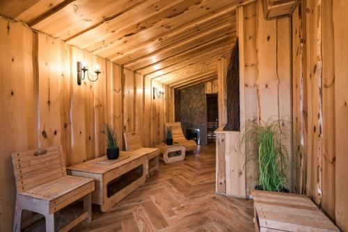 a room with wooden walls and wooden floors and benches at Dadajowa Osada - Dadaj in Biskupiec