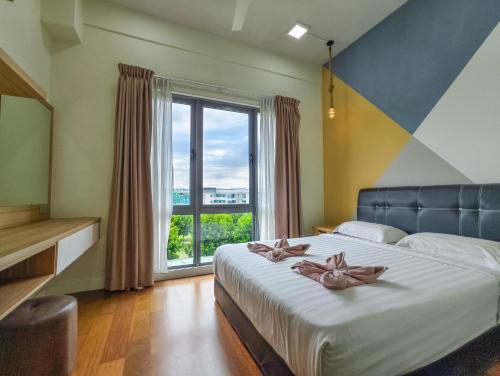 a bedroom with a bed with a large window at AJ Suites @ Loft Imago KK in Kota Kinabalu