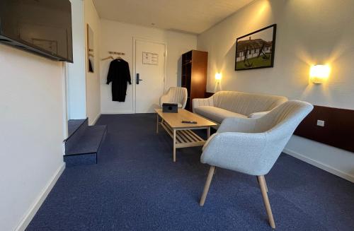a living room with a couch and a table at BB-Hotel Frederikshavn Turisthotellet in Frederikshavn
