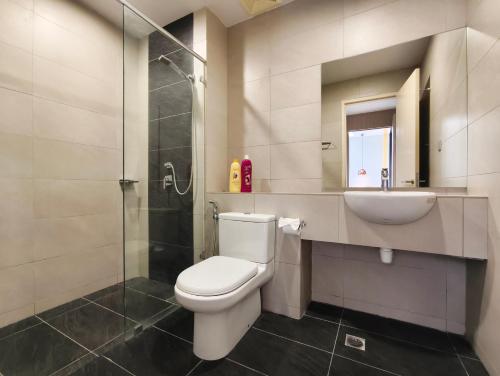 a bathroom with a toilet and a sink and a shower at AJ Suites @ Loft Imago KK in Kota Kinabalu