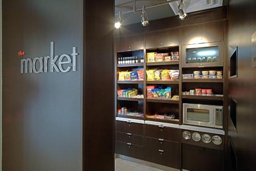 a kitchen with a refrigerator and a microwave at Courtyard Chesapeake Greenbrier in Chesapeake