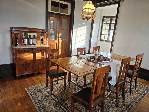 a dining room with a wooden table and chairs at GuestReady - Countryside atmosphere in Sernancelhe in Fonte Arcada