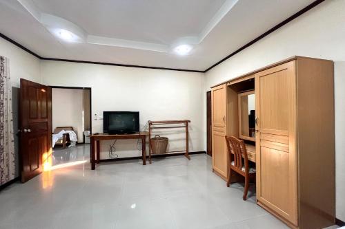 a living room with a television and a desk at Saithong Resort in Udon Thani
